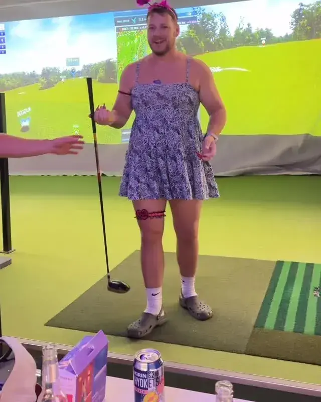 KGOLF indoor golf simulator party event with a player in costume on a screen golf bay