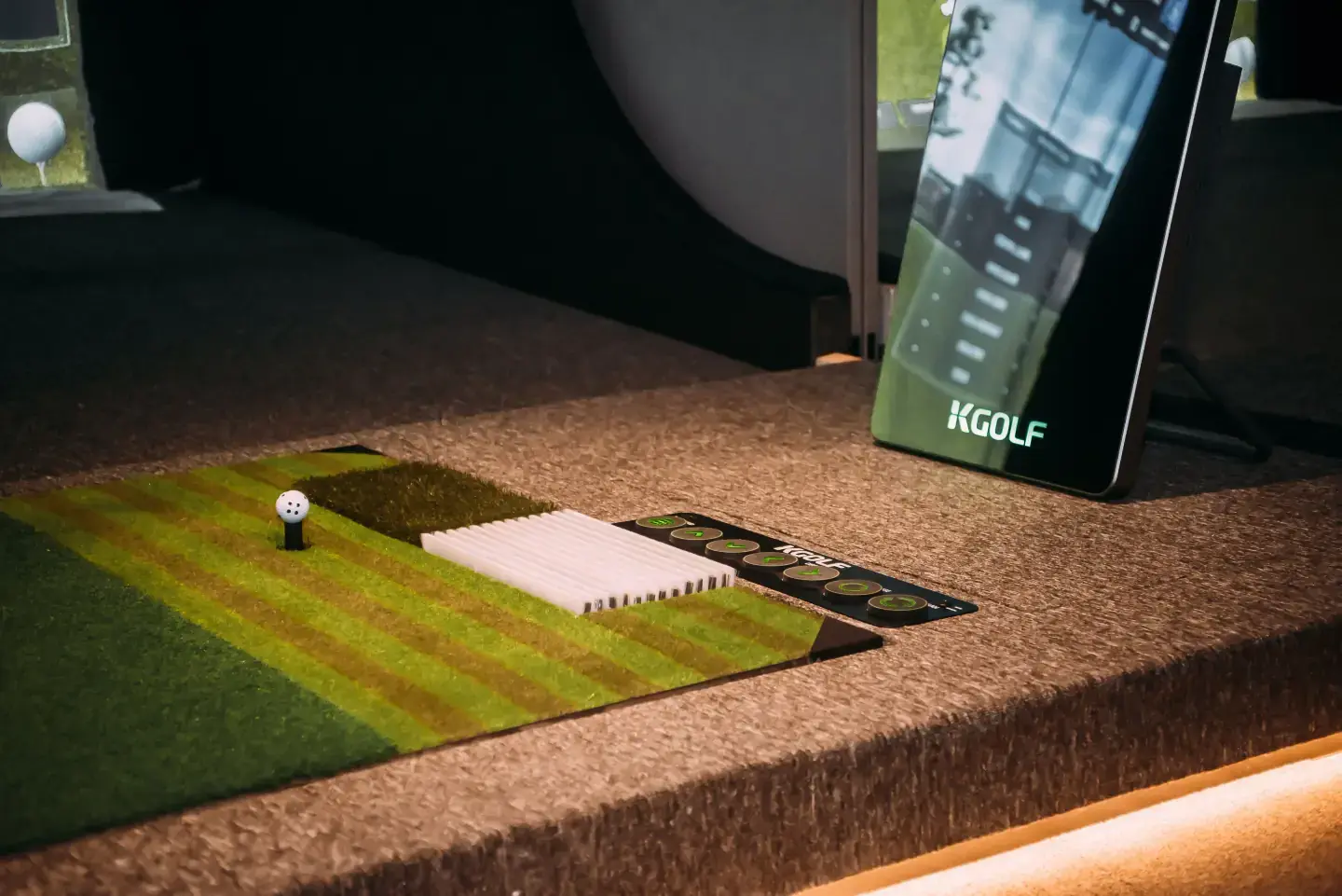 Premium golf simulator hardware hero background with KGOLF swing plate installation
